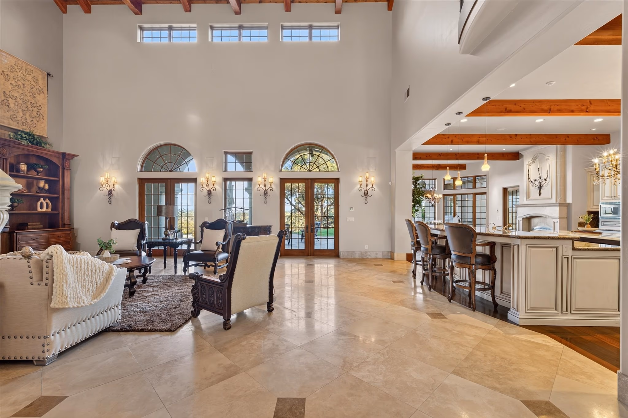 Paired stone columns and arches framing the formal dining room beyond, in the main residence.