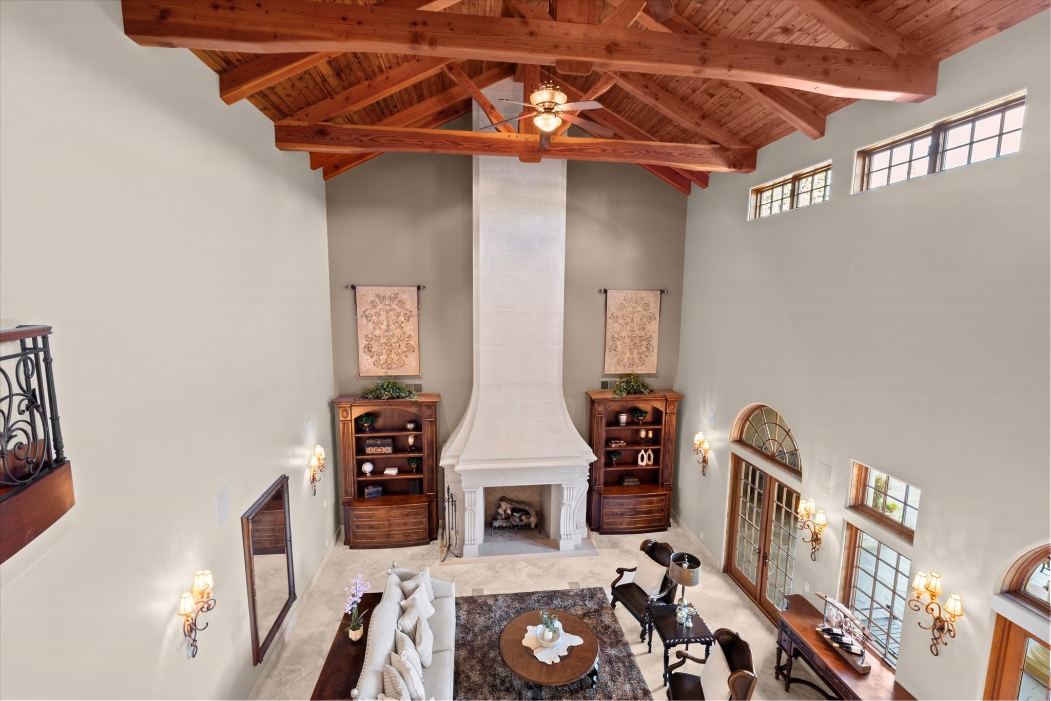 The upstairs landing looking down into the great room, with the timber ceiling structure at eye level.
